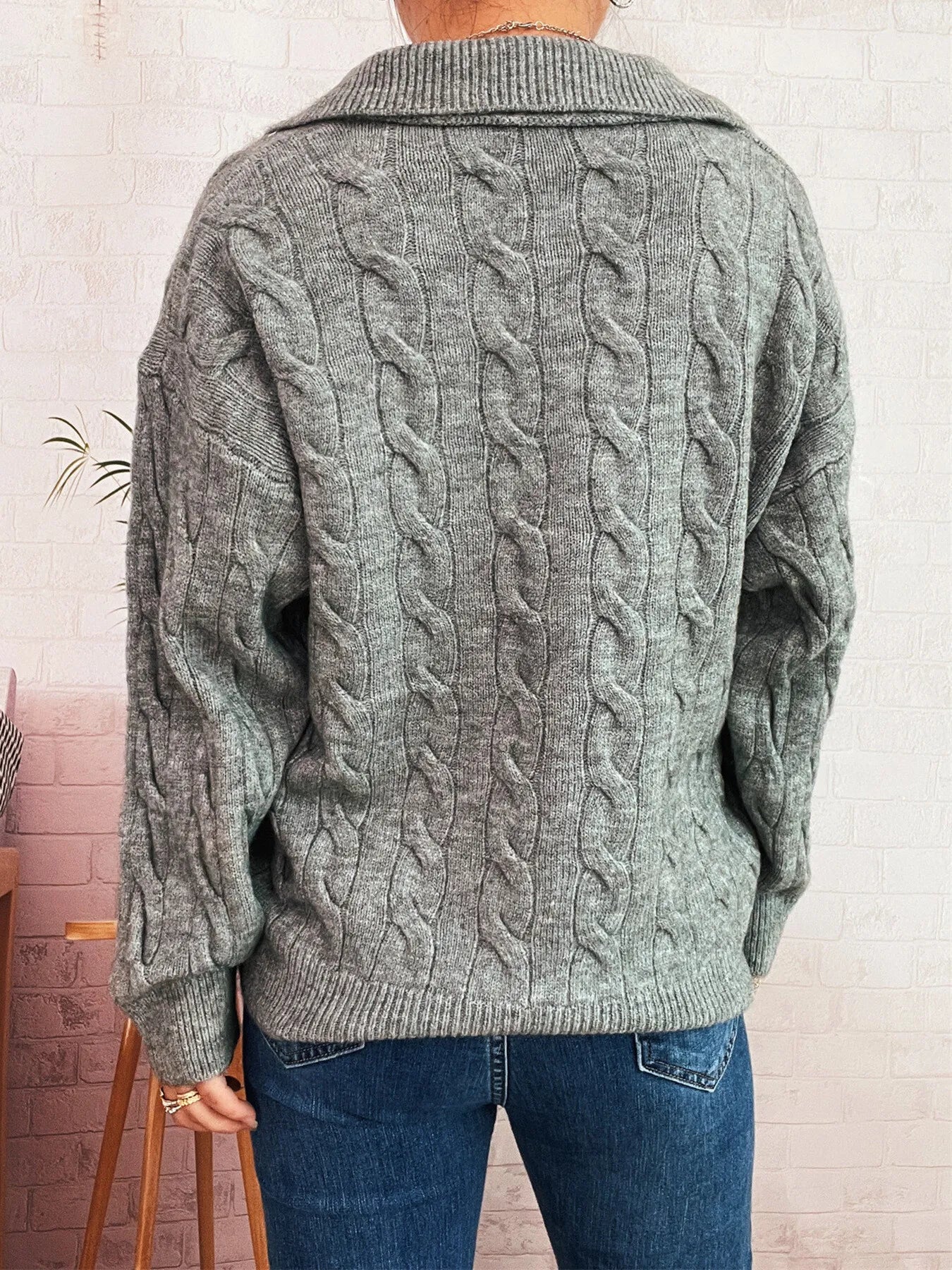 Gray cable-knit sweater with johnny collar, long sleeves, cable-knit back panel.