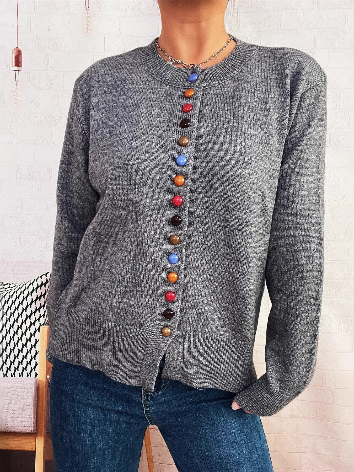 Gray button-front cardigan with long sleeves and a vertical row of colorful accent buttons