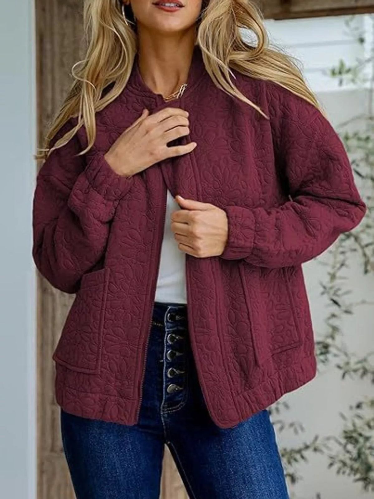 Quilted zip-front floral jacket in burgundy, front zip and textured quilting.