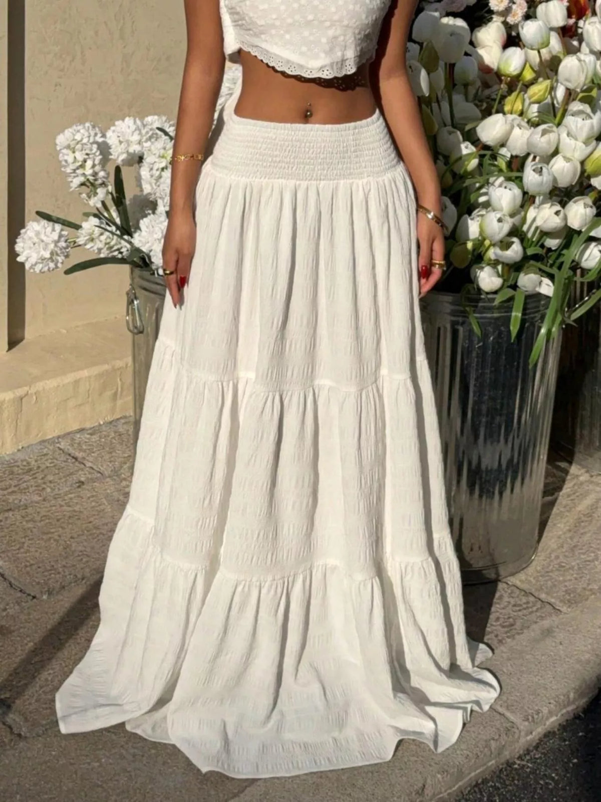 White flowy maxi skirt with smocked waistband and layered ruffle bands