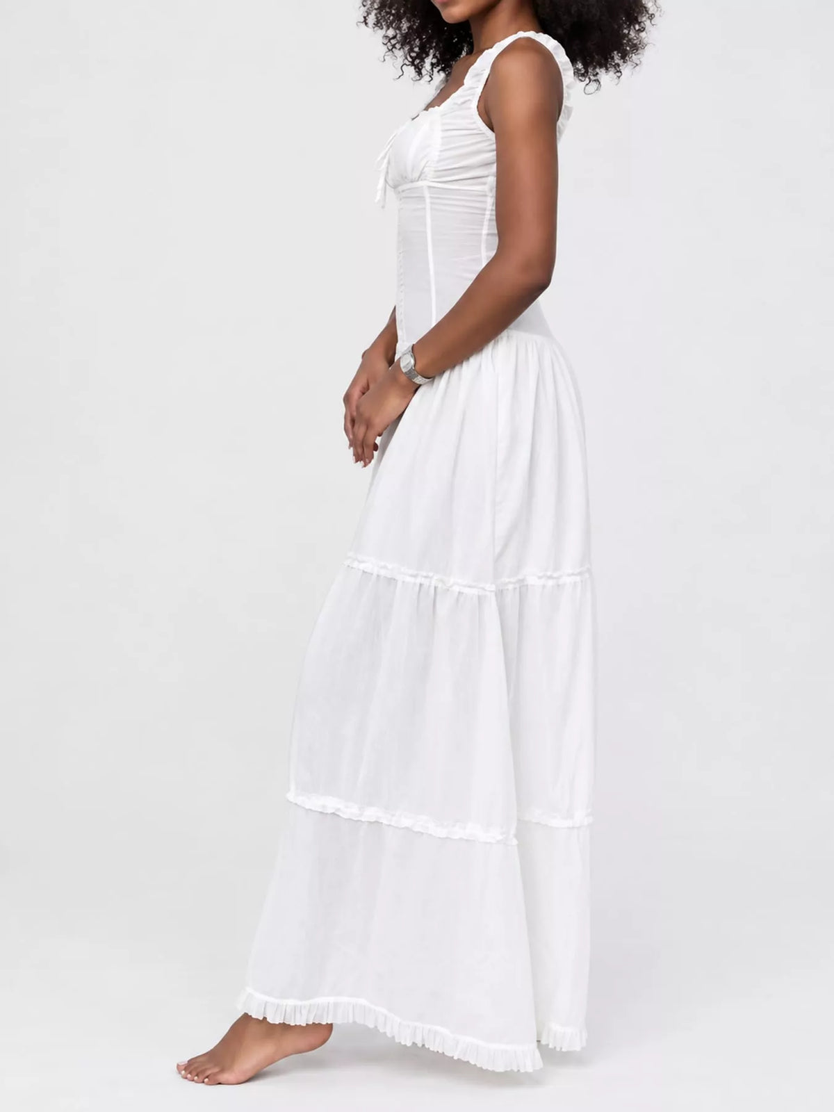 White cotton maxi dress with ruffled square neck, sleeveless tiers, and gathered waist