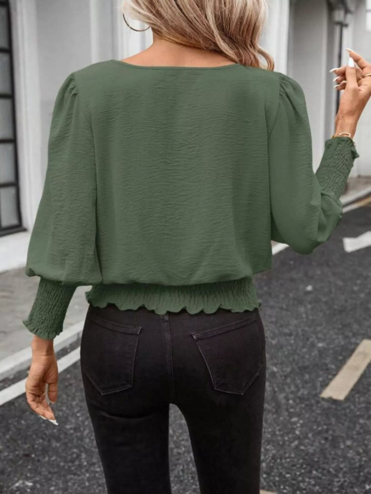 Green puff-sleeve smocked polyester blouse shown from the back, elastic hem