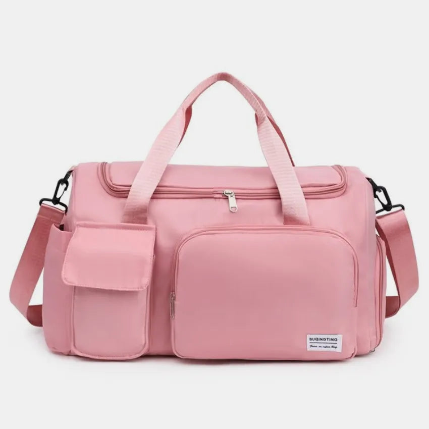Large travel duffle bag with detachable straps, dusty pink with front zip pocket.