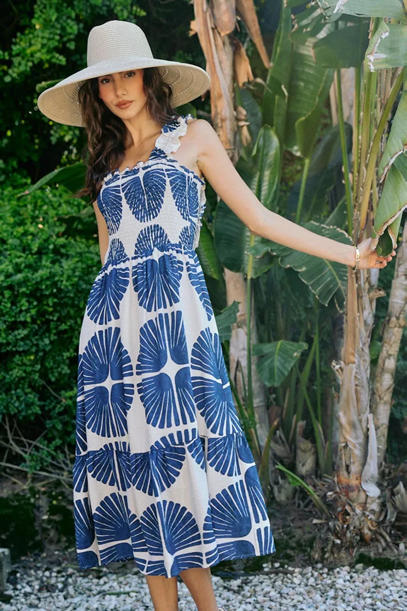 Sleeveless tiered midi dress with smocked bodice and navy abstract print, white ground