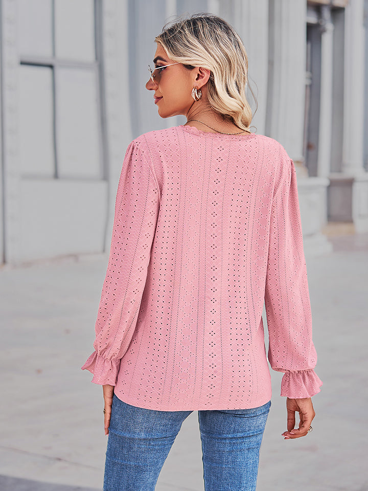 Blush pink eyelet V-neck blouse from back view with gathered flounce cuffs