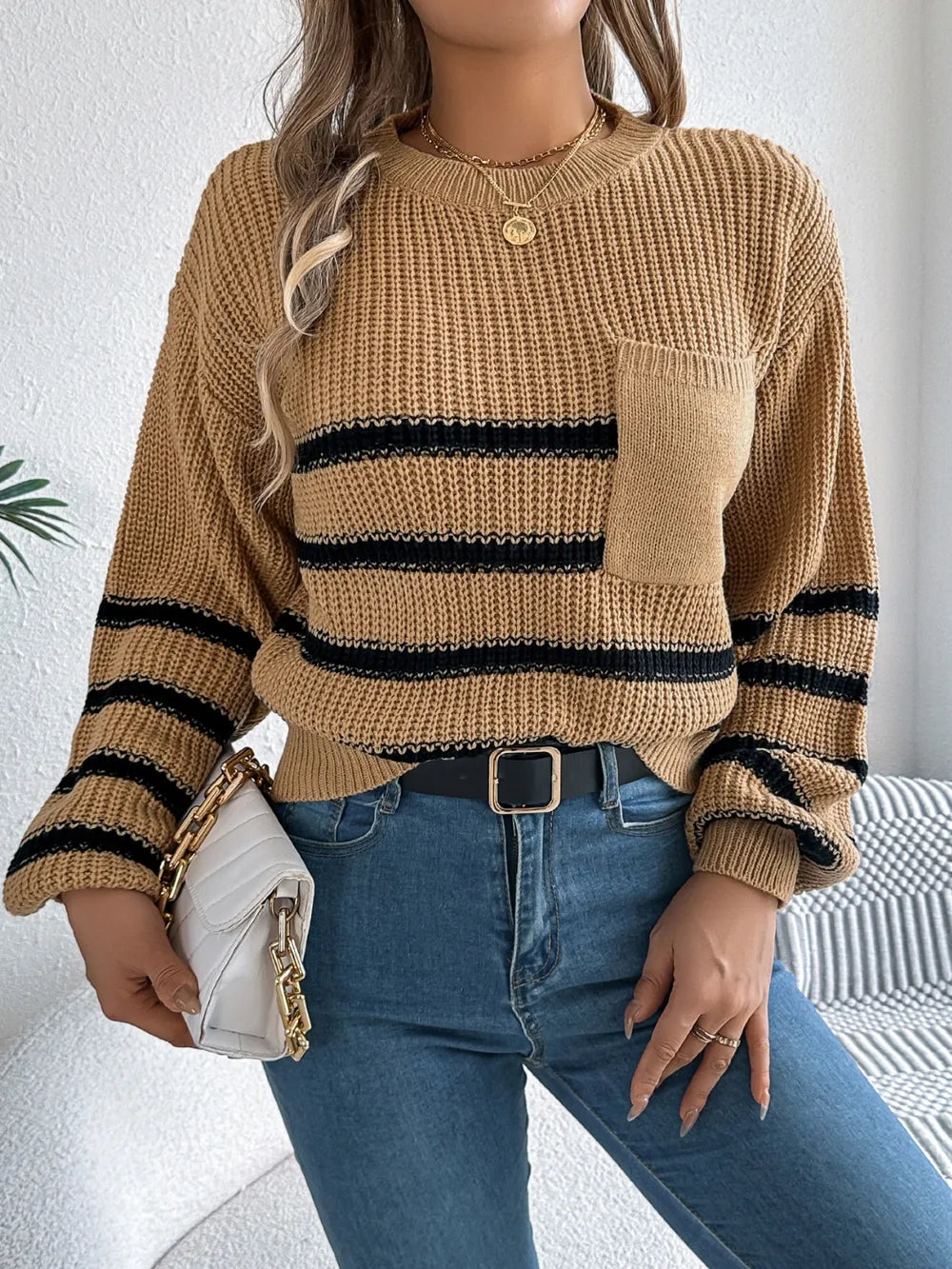 Caramel striped knit sweater with round neck, long sleeves, chest pocket and ribbed hem