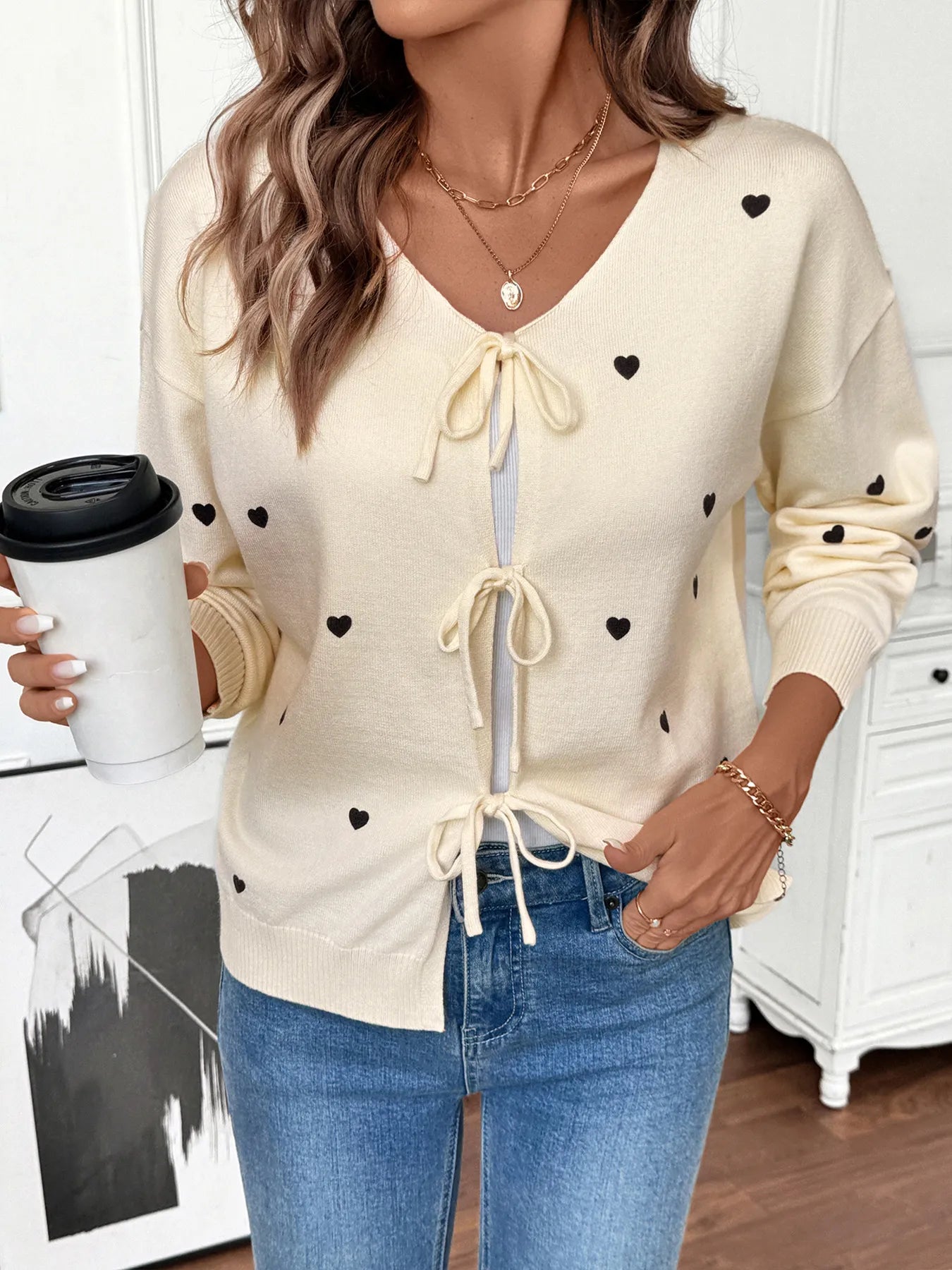 Cream heart tie-front long sleeve cardigan with front bow ties and ribbed cuffs
