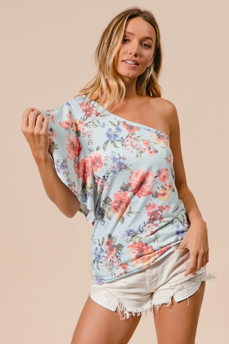 Light blue floral jersey knit top with one-shoulder neckline and cascading ruffle