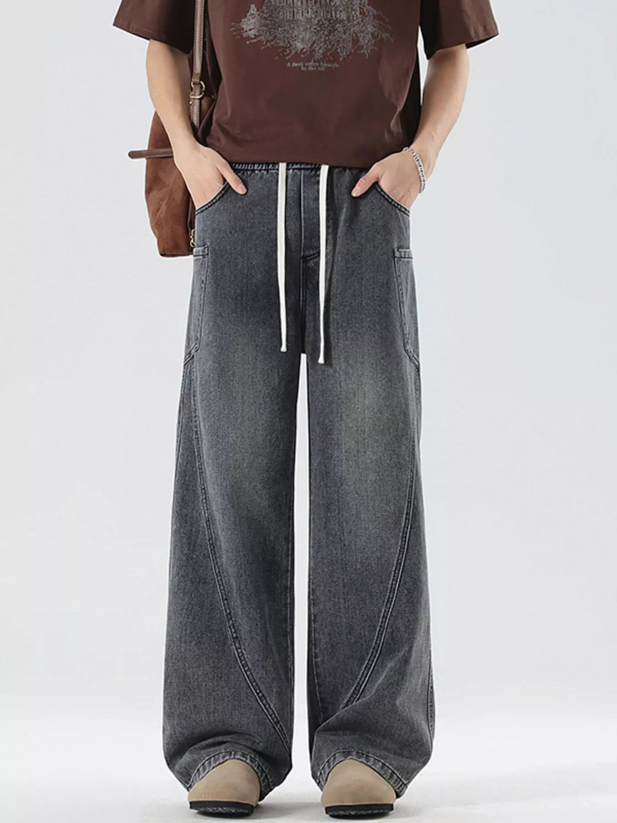 Men's vintage wide-leg jeans in dark gray denim with drawstring waist, loose fit.