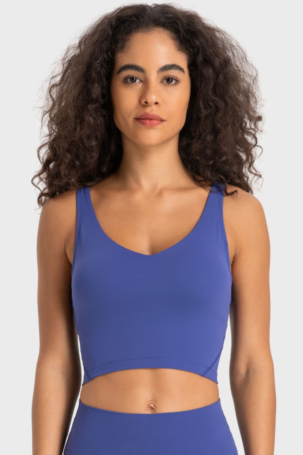 Deep V-neck crop sports bra with racerback, cobalt-blue color, front view.