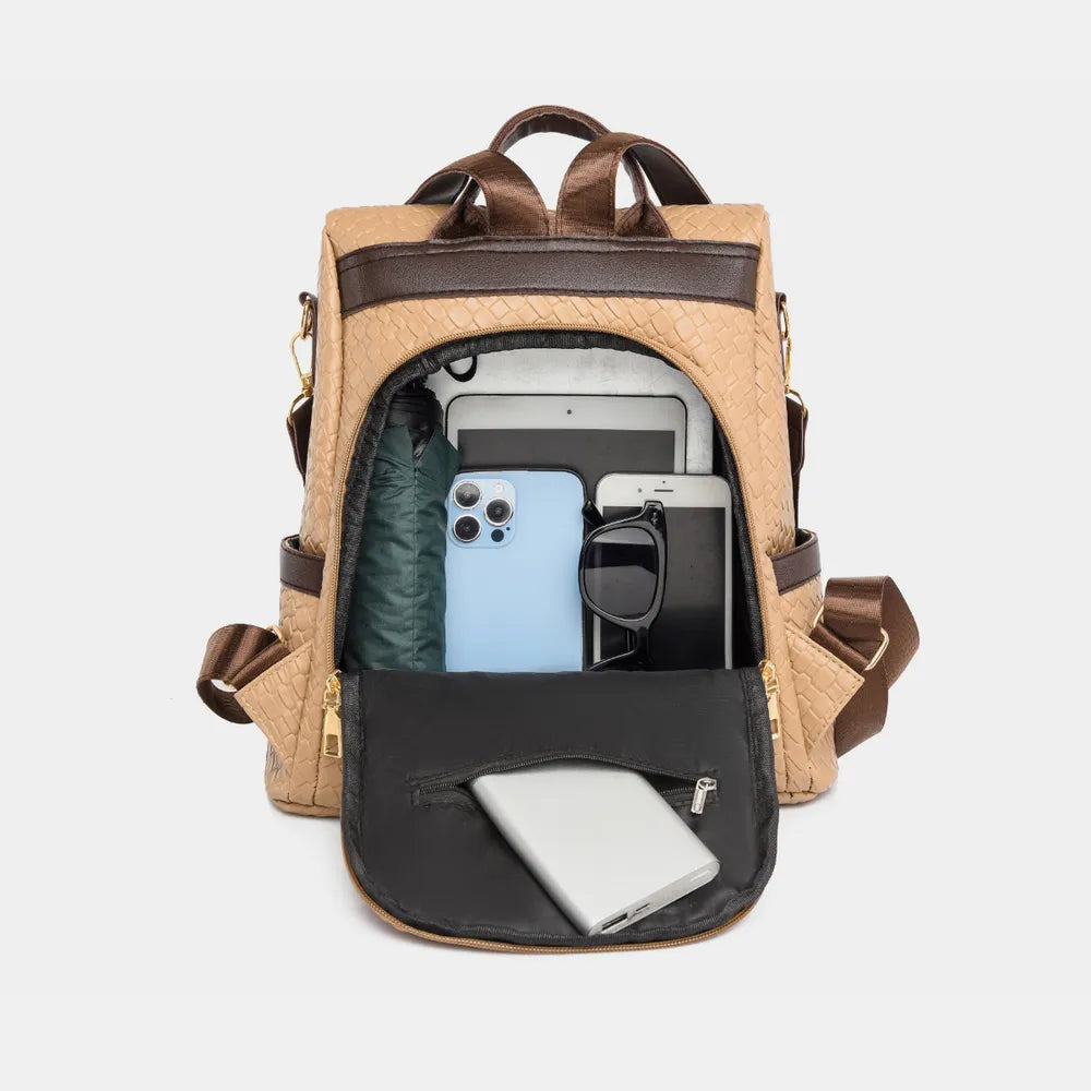 Vegan leather backpack bag in tan with open top showing interior and front pocket.