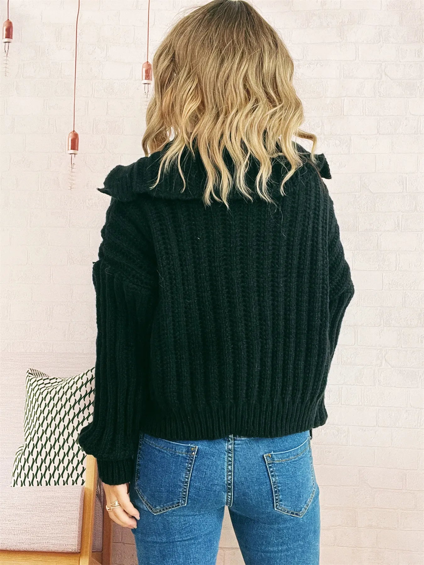 Dark button-up knit cardigan with long sleeves, ribbed cuffs and hem.