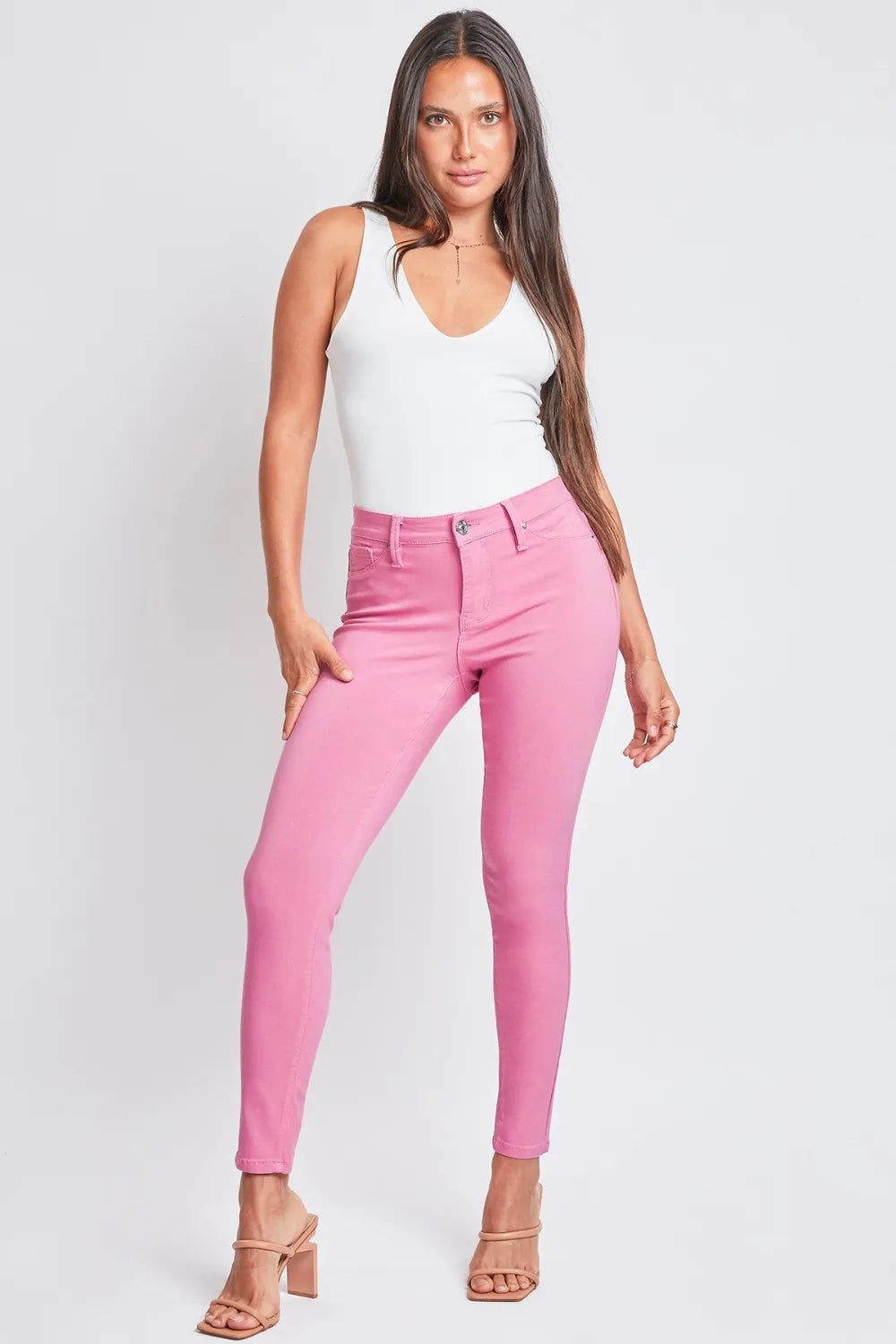 Hyperstretch mid-rise skinny pants in pink with button-fly and belt loops