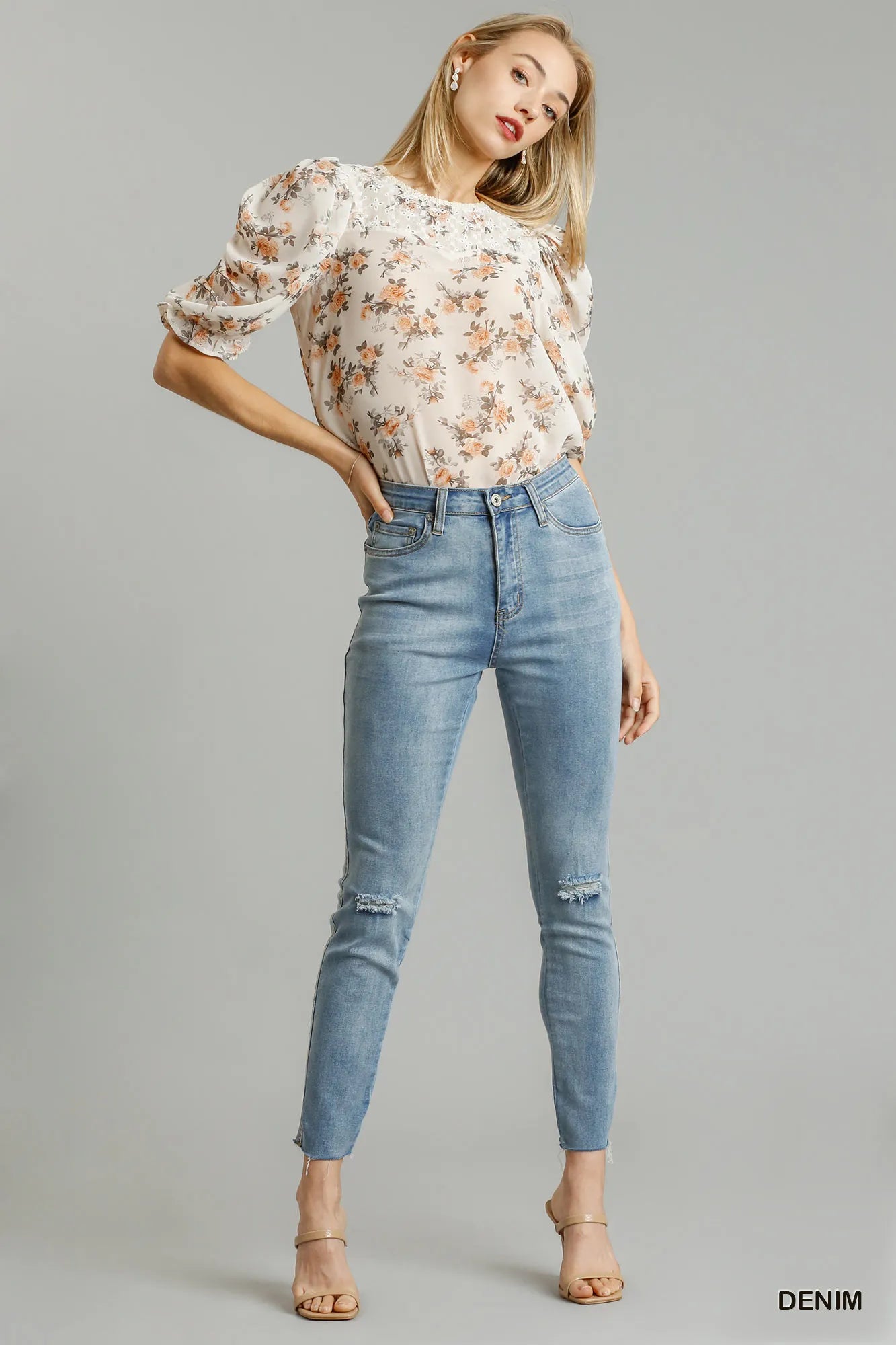 Light wash stretch skinny jeans with 5 pockets, distressed details, unfinished hem
