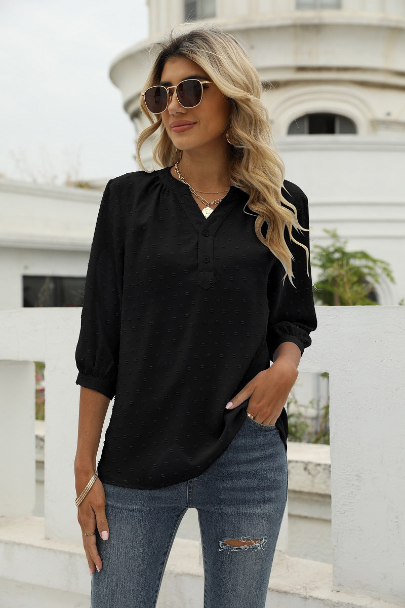 Black Swiss-dot blouse with notched V-neck, 3/4 sleeves, and button placket