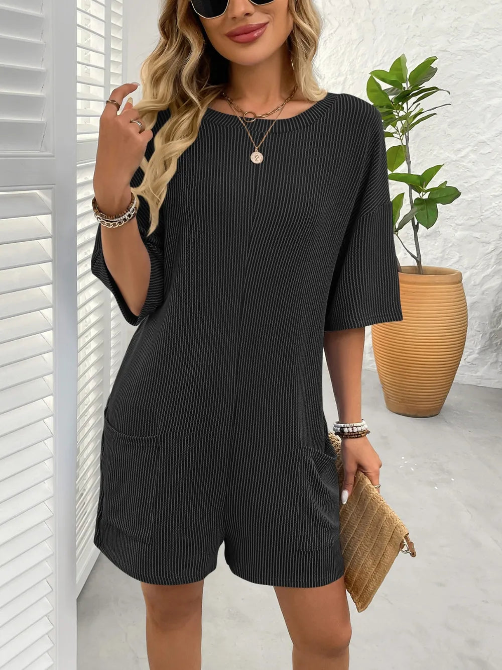 Backless textured romper, black, round neckline, half sleeves, pockets on front