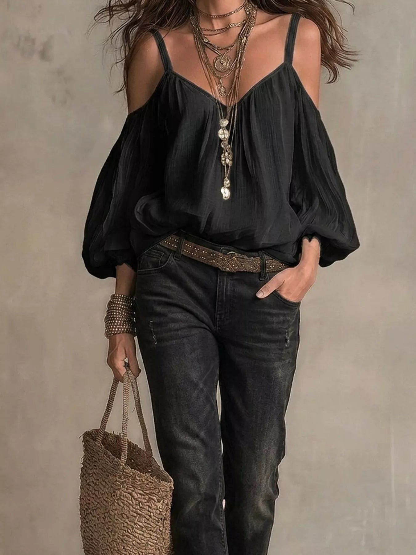 Black cold-shoulder balloon sleeve blouse with thin straps and tassel V-neck