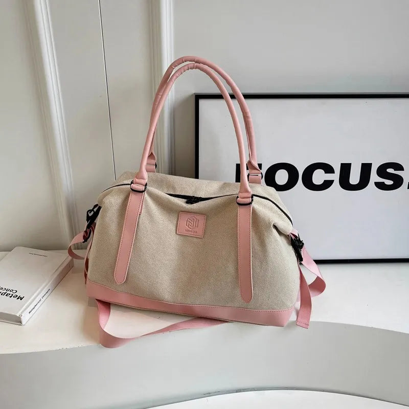 Large polyester duffle bag in beige with blush pink contrast handles and straps