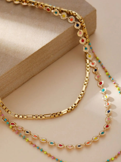 Gold-plated layered resin bead necklace, close view of oval beads and link chain