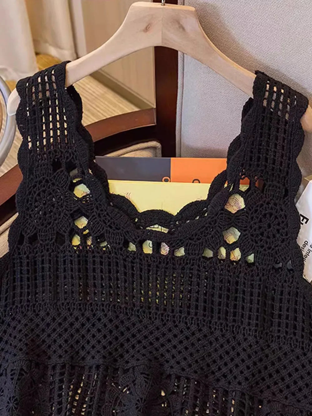 Black crochet scoop neck tank with open lattice texture and decorative gold-toned studs