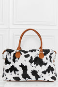 Cow print brushed weekender bag with brown handles and zip-top closure