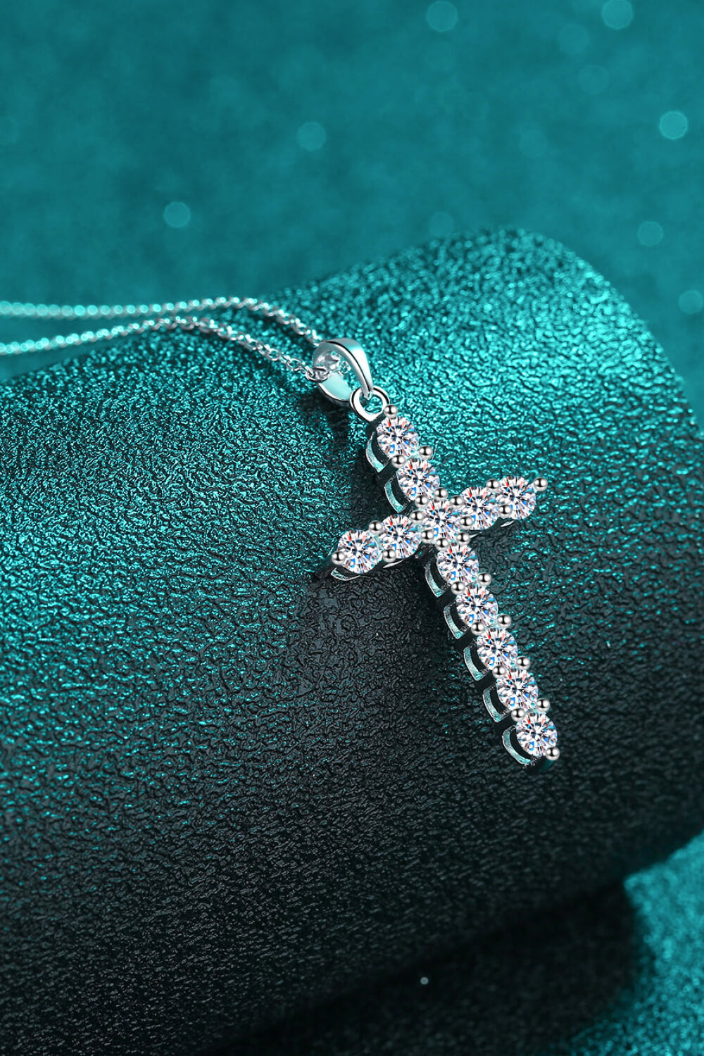 Sterling silver cross pendant necklace with pavé stones, side view