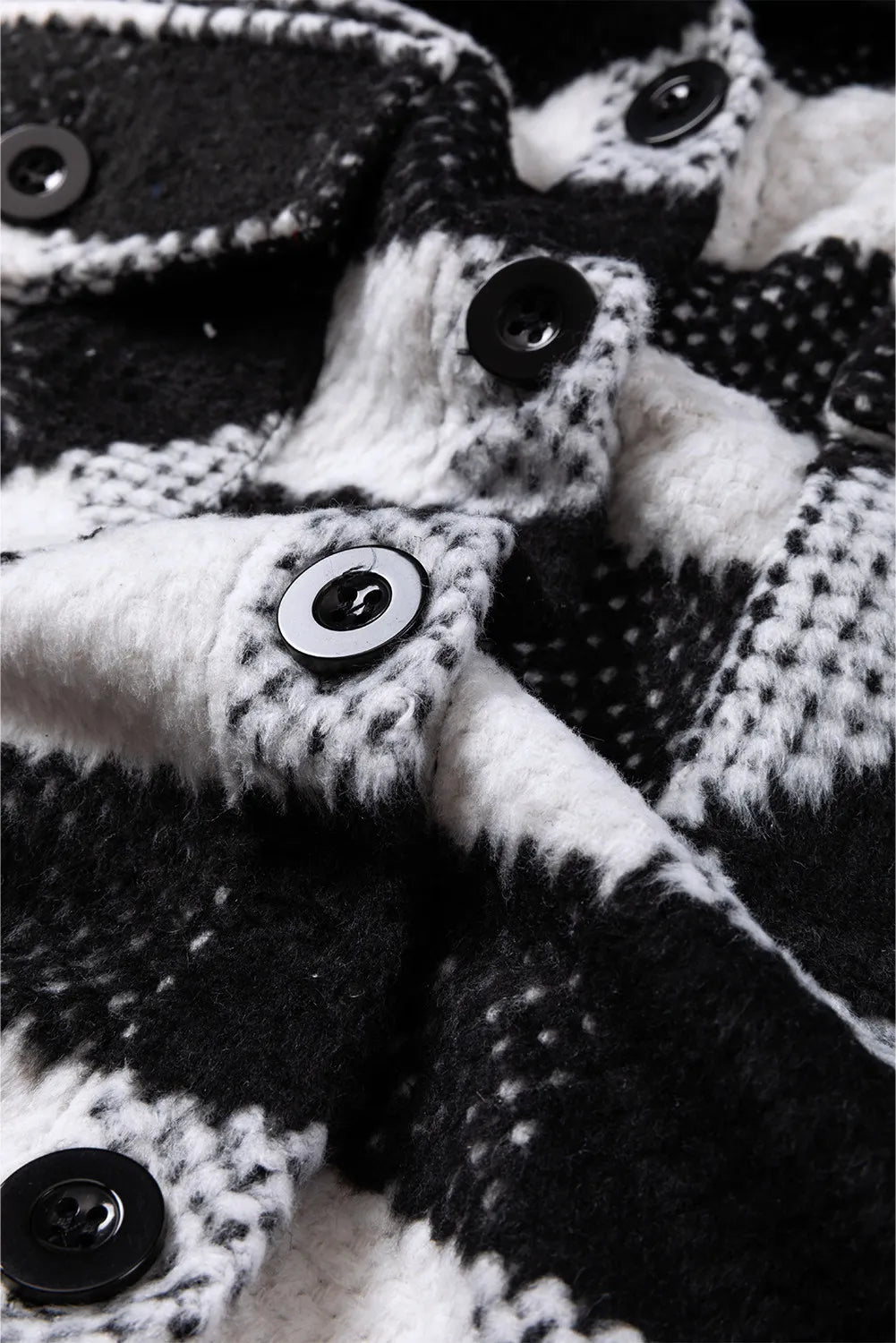 Black-and-white plaid jacket with button front and fuzzy textured fabric close-up
