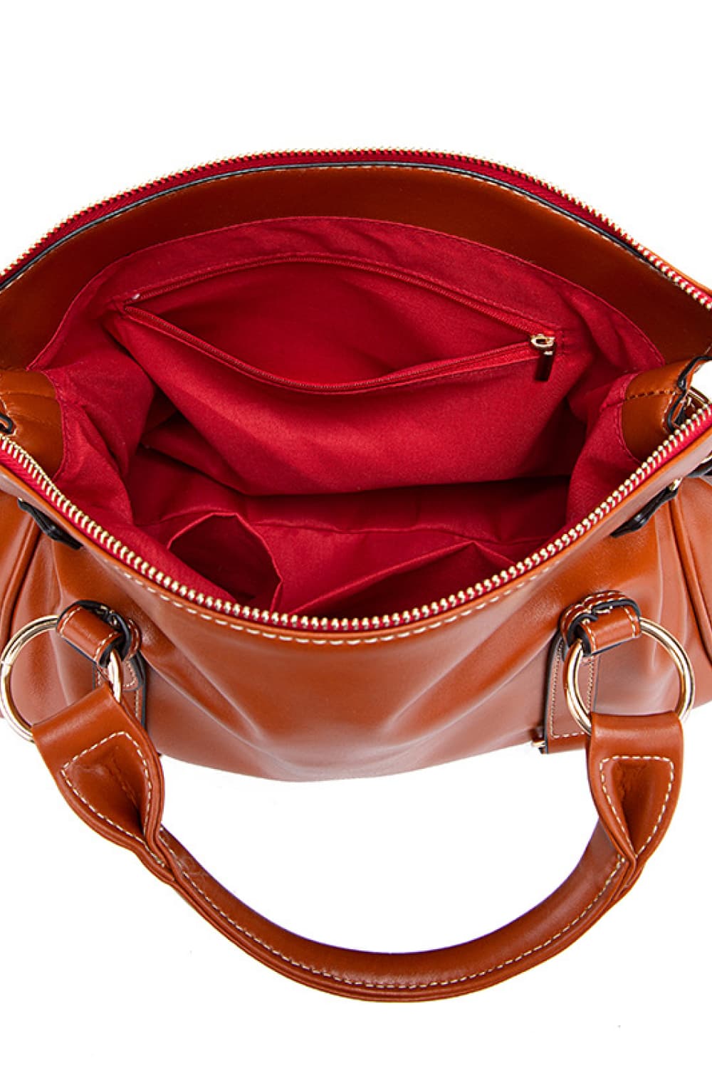 PU leather handbag in brown with tassels, open top showing red-lined interior and zipper.