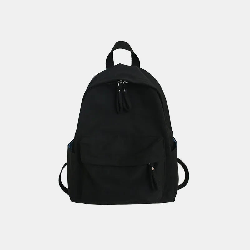 Black cotton zip backpack with top handle, front pocket, and adjustable shoulder straps