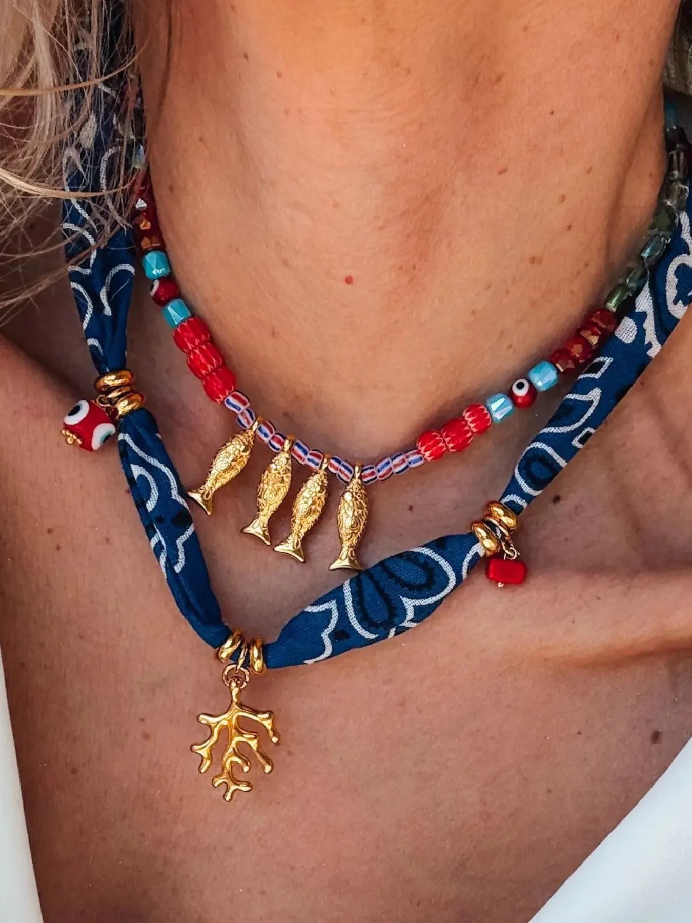 2-piece necklace with gold fish charms, red bead strand and navy cord