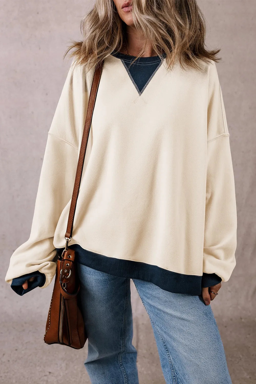Ivory long-sleeve sweatshirt with V-contrast yoke and ribbed dark cuffs