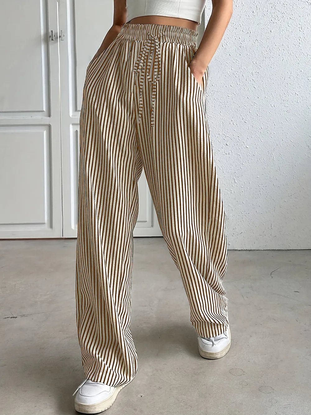 Striped elastic waist drawstring pants in tan and white, relaxed full-length fit