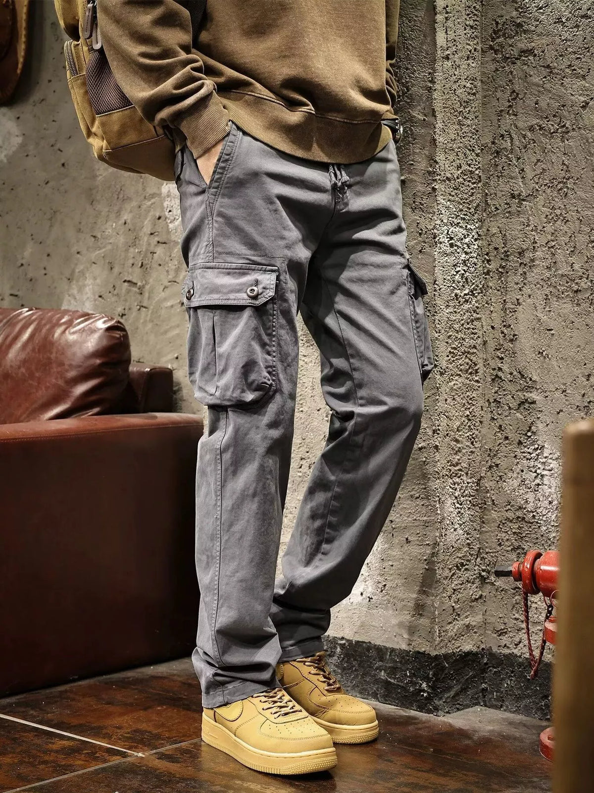Mens multi-pocket drawstring cargo pants in gray with side cargo pocket detail