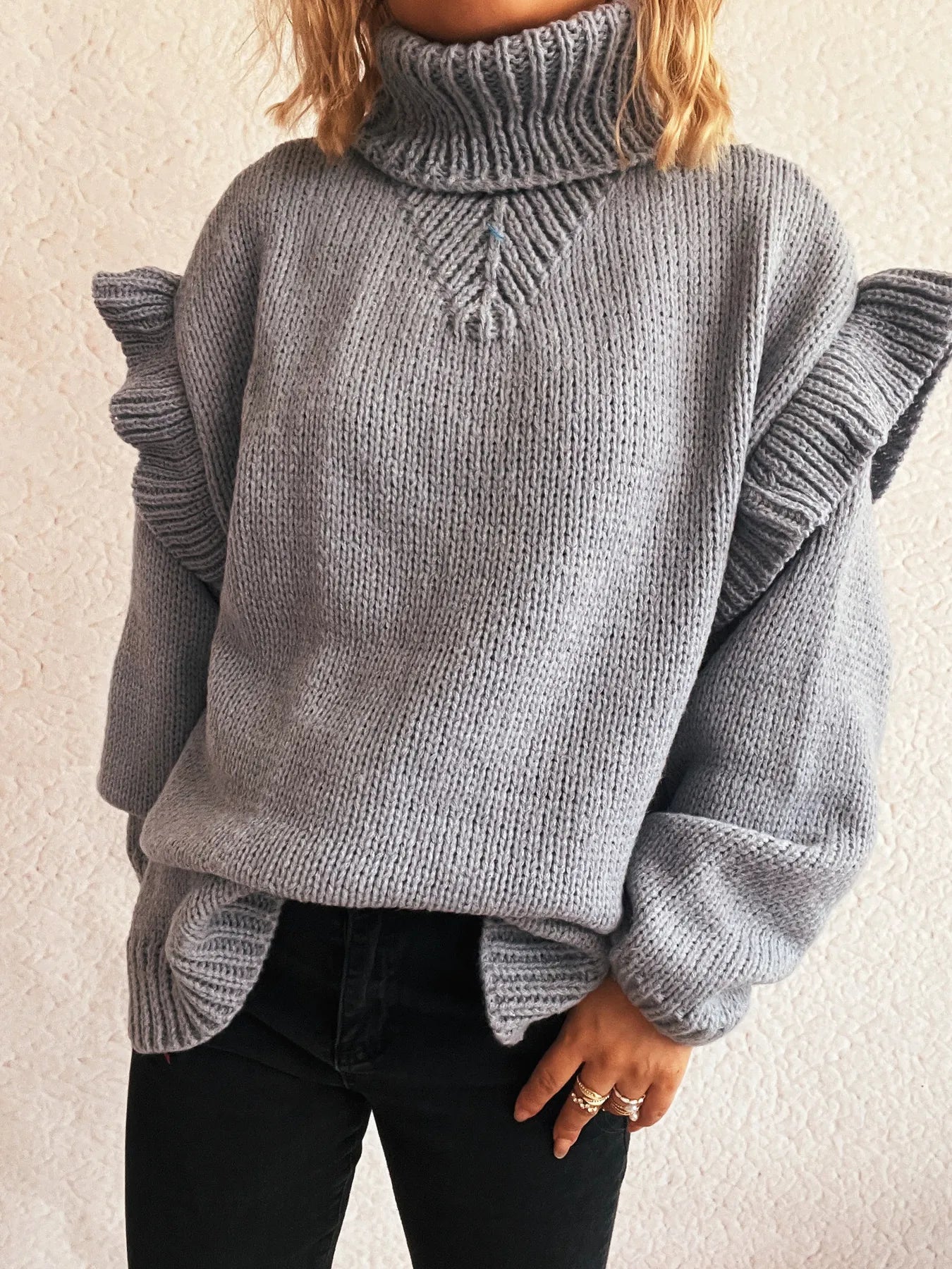 Grey ruffled turtleneck long-sleeve knit sweater with textured cable knit front