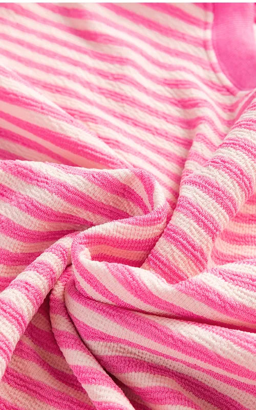 Close-up of pink-and-white striped sweatshirt knit fabric
