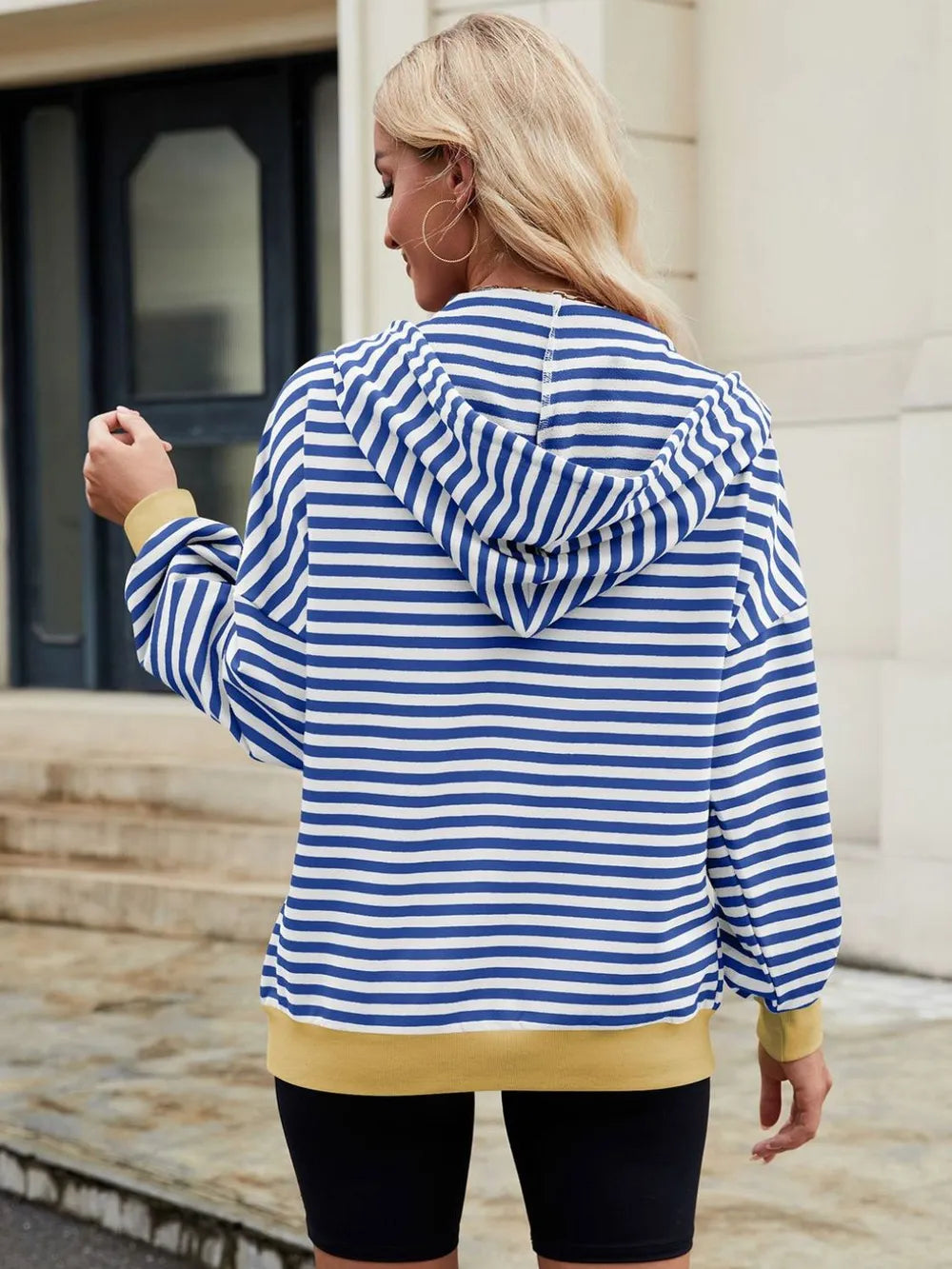 Blue and white striped zip-up hoodie with hood and long sleeves, back view