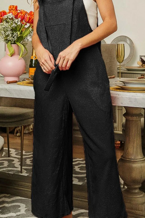 Black textured jacquard jumpsuit with front detail, wide legs, and side pockets