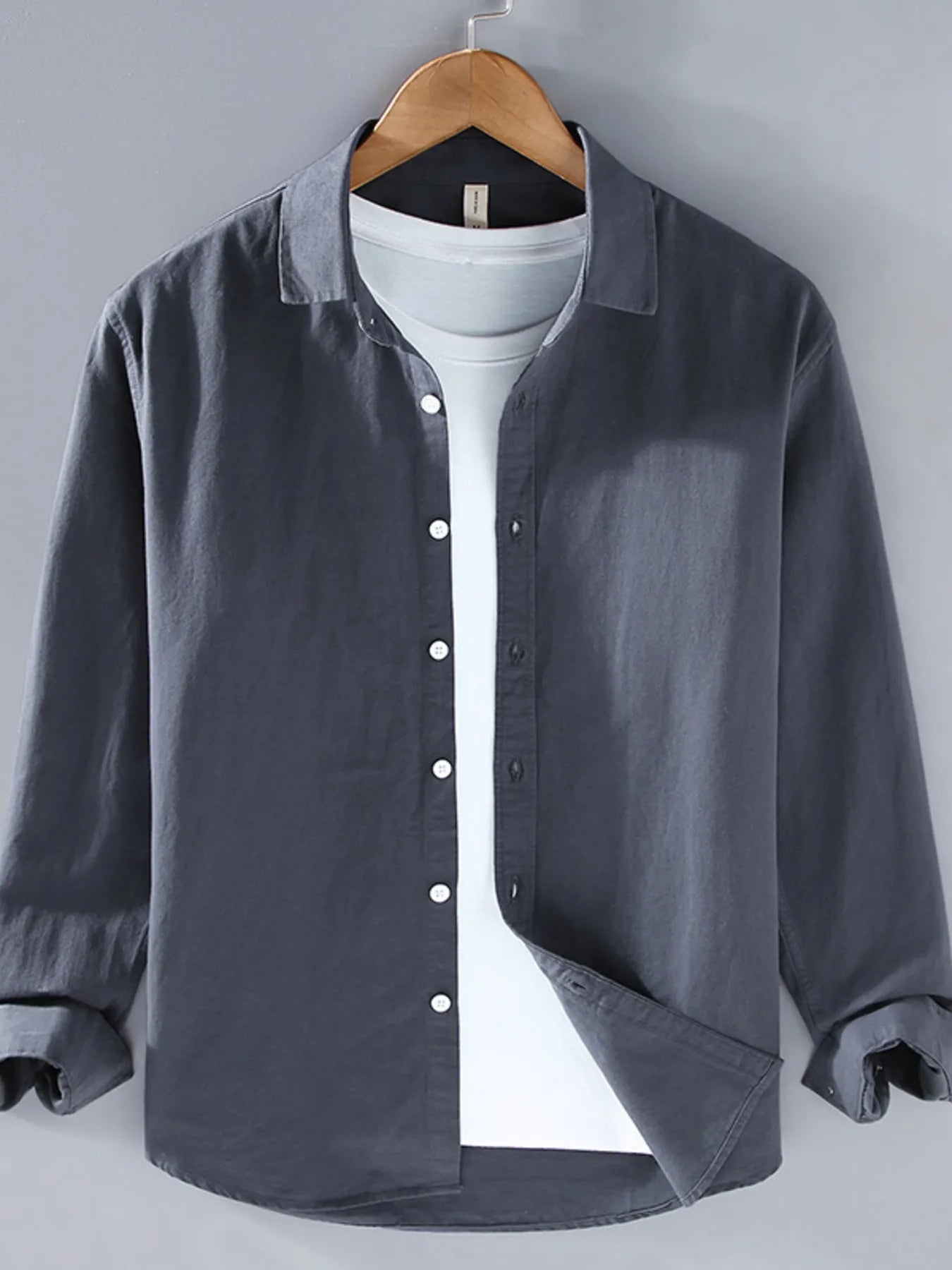 Dark gray button-up long sleeve shirt with pointed collar and front button placket.