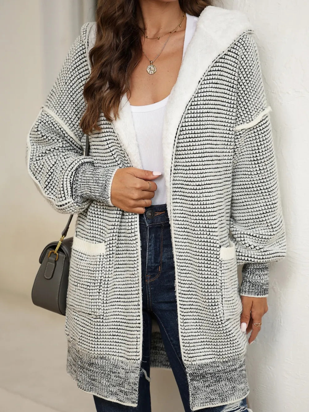 Open-front hooded winter coat with pockets, open-knit gray-and-white texture, white hood lining.