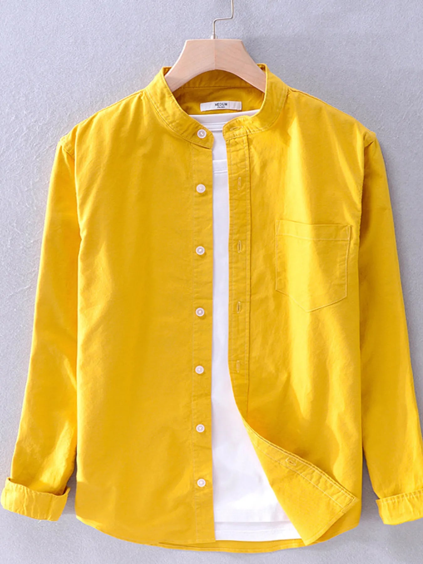 Long-sleeve button-up shirt in bright yellow with front buttons and chest pocket