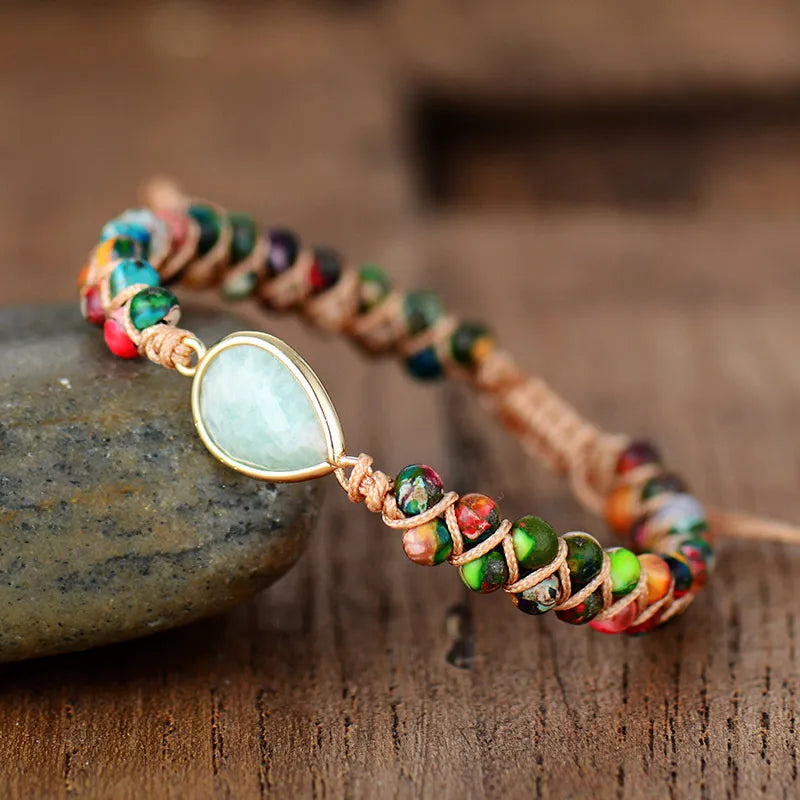Multicolor beaded bracelet with light blue teardrop stone in gold-tone setting