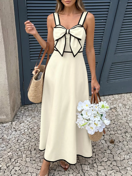 Beige A-line midi dress with bowknot front and black-trimmed spaghetti straps.