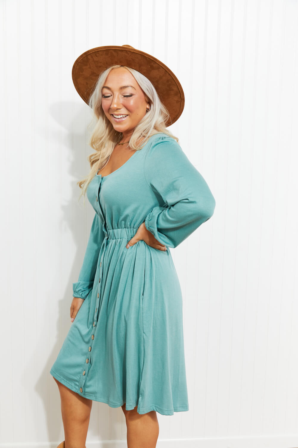 Scoop-neck empire-waist mini dress with long sleeves and button front, teal blue