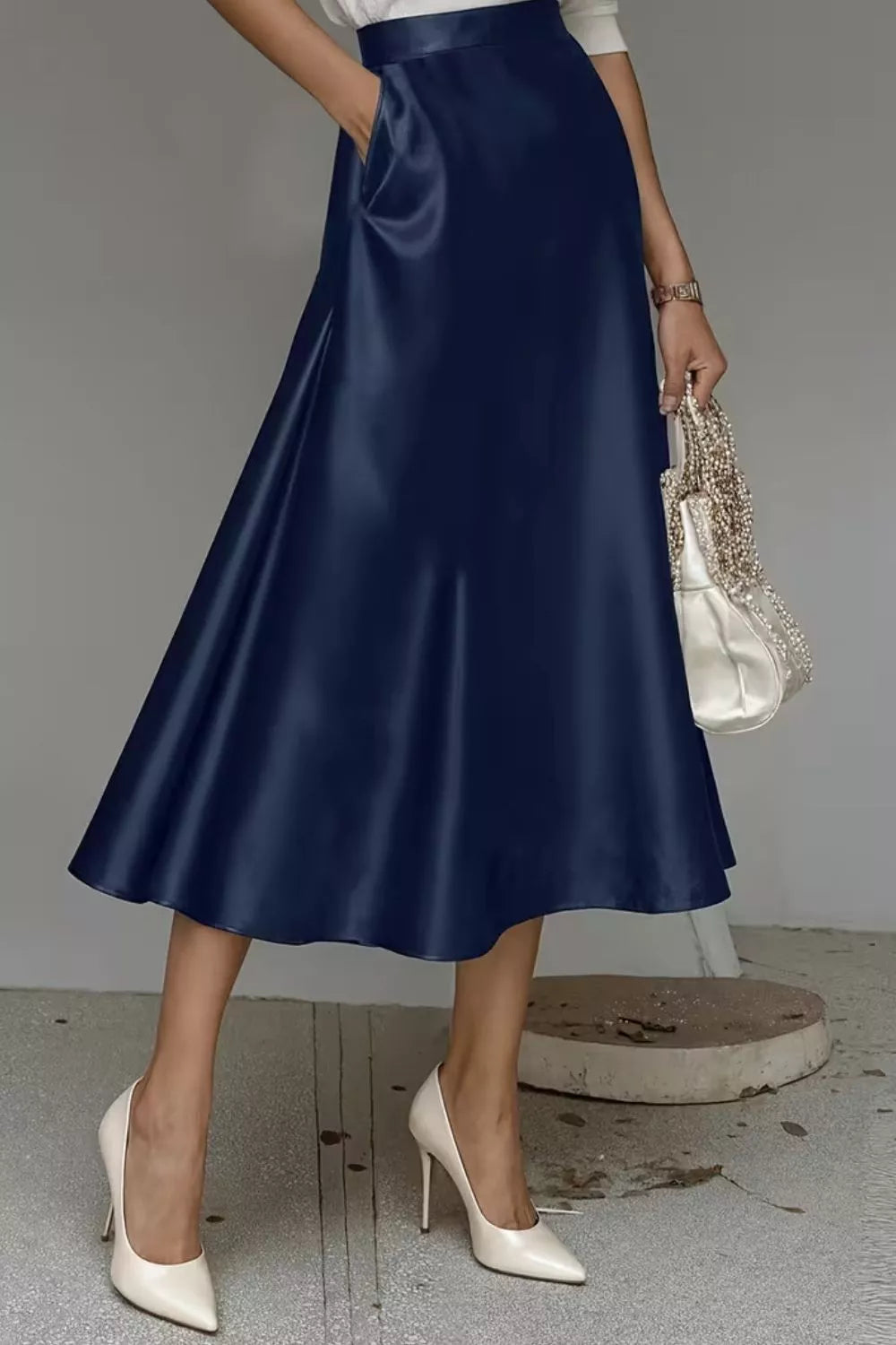 Satin A-line midi skirt in navy with gathered waist and side pockets