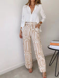 Button-down shirt and geometric patterned pants set in cream and tan.