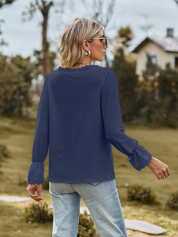 Flounce-sleeve blouse in navy, V-neck style with cuffed sleeves, back view