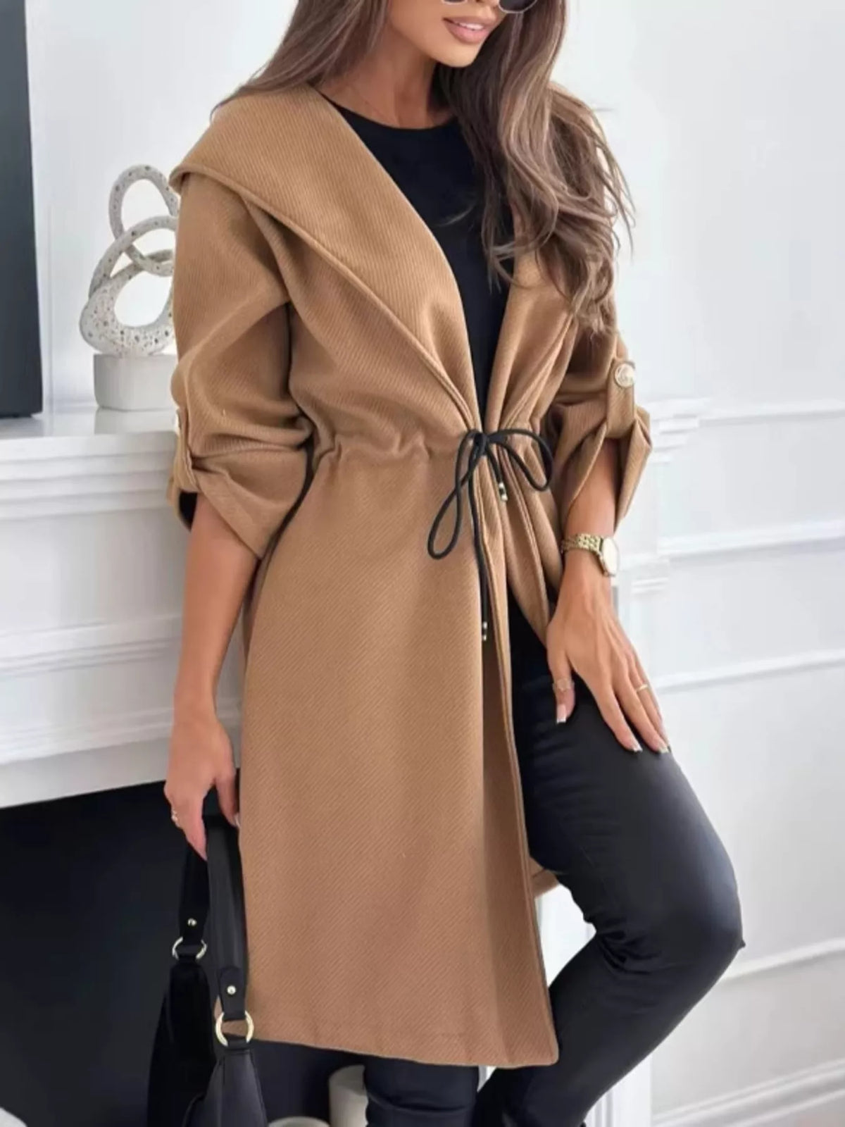 Light brown hooded jacket with front closure and black drawstring waist, side pockets