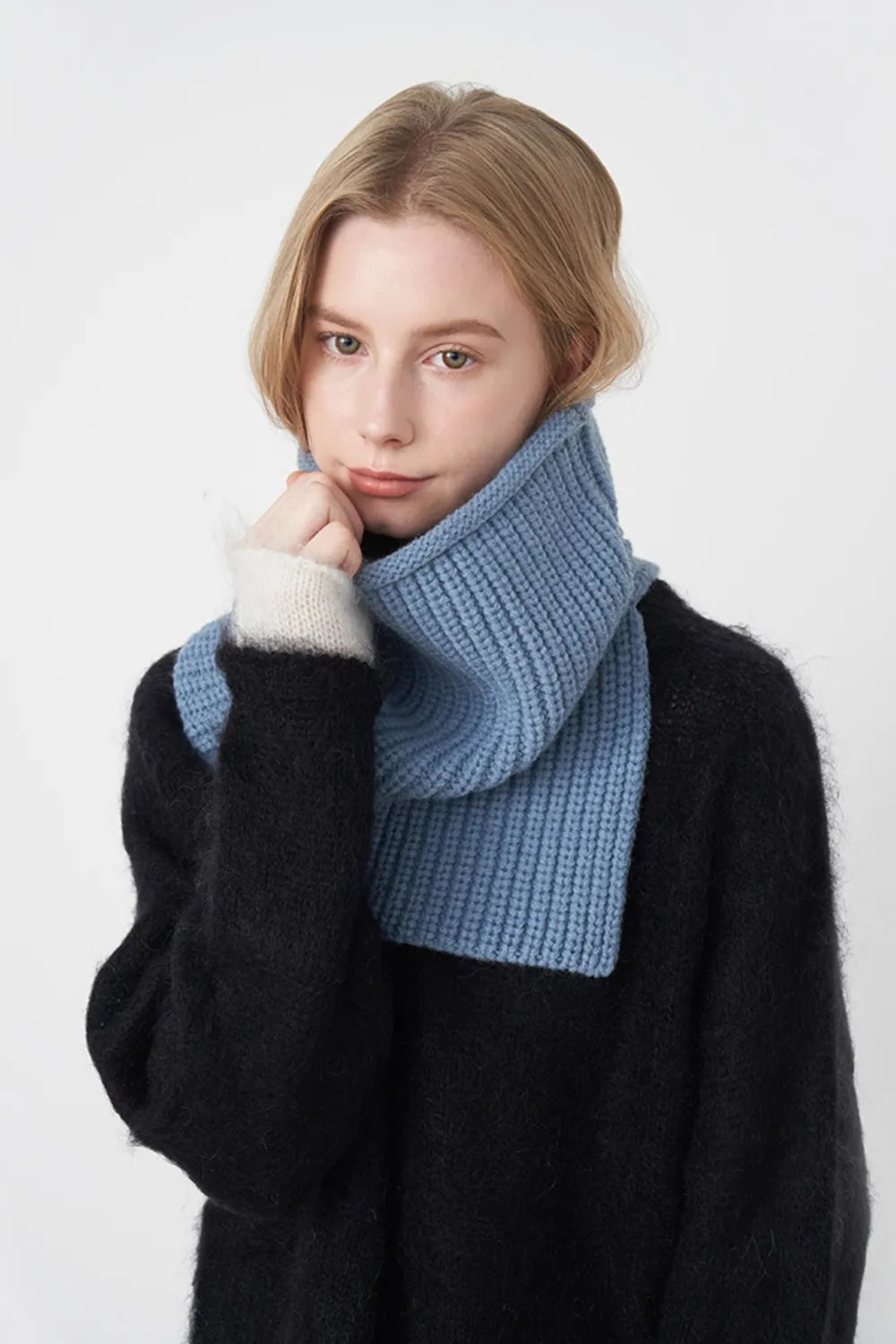 Sky blue ribbed knit pullover scarf worn as a thick folded cowl