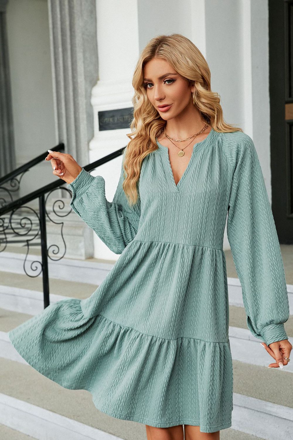 Light green notched-neck long-sleeve mini dress with flowing skirt and V-neck