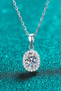 Silver moissanite pendant necklace with oval stone and halo, on chain